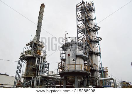 Rectification column large metal container furnace at the oil refinery. Equipment for petrochemical production.