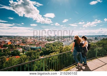 Vilnius, Lithuania - July 5, 2016: Two Young Girls Women Looking At View Of Vilnius Old Town From Viewing Platform Near Three Crosses Monument. Unesco World Heritage Site.