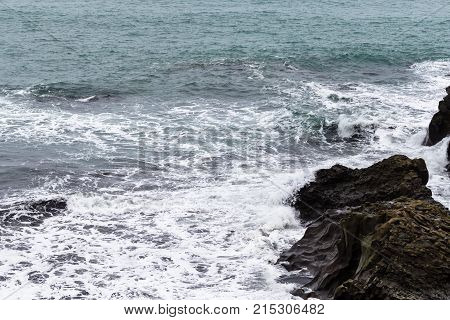 Surf And Rocks In Atlantic Ocean In Iceland