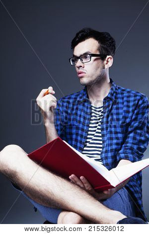 Handsome Male Student With Beard Wreating And Reading Book. (knowledge Education Development Concept