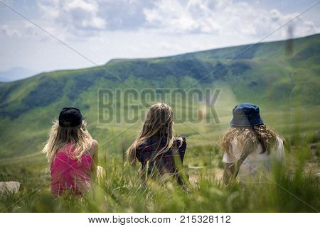 Three girls looking on the mountains in the Carpathians mountains