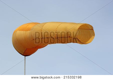 Wind direction Flag on blue cloud sky in wind