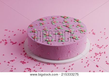 pink velvet cake with roses and leaves on a pink background