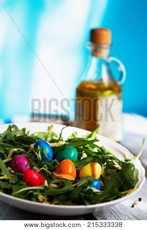 Easter salad from arugula and colored quail eggs