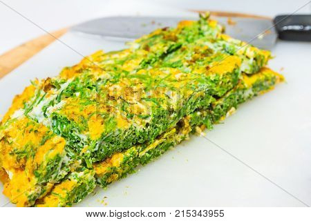 Climbing wattle (Cha-om) omelette cutting into rectangular pieces