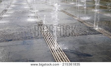The city's fountain on the square is beating from the ground.