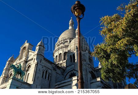 The basilica Sacre Coeur is a Roman catholic church located at the summet of the butte Montmartre , the highest point in Paris.