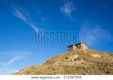 Timmelsjoch High Alpine Road house on the hill landscape. Mountains and peaks natural environment. Hiking in the Passo del Rombo. Ötztal alps Austria and Italy border Europe