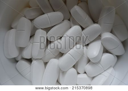 Container With Big White Calcium Citrate Tablets