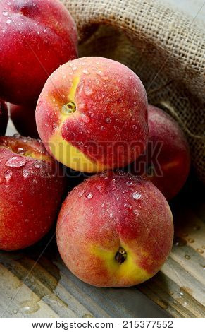 Many Fresh Peach with water drops and shadow on wooden background
