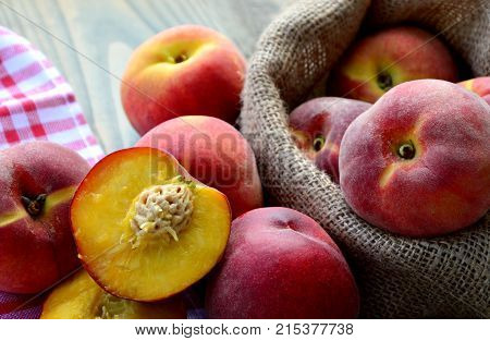 Many fresh peach in sack bag (German name is Pfirsich)