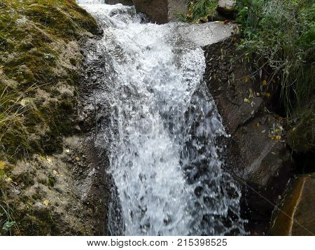 Waterfalls in the mountains of the North Caucasus surrounded by beautiful autumn nature