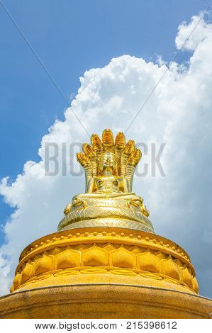Golden Buddha Statue With Seven  Naga Heads Under On Blue Sky