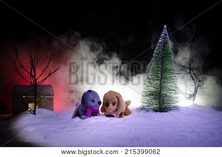 Toy Dog - A Symbol Of The New Year Under The Snow Against The Background Of Fir Branches. Toy's Dog 