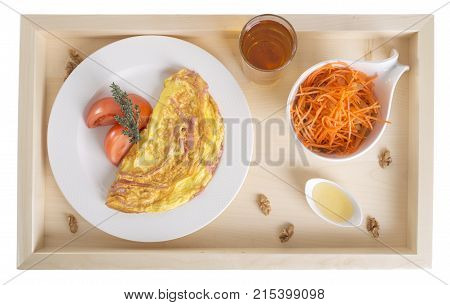 Ham omelet with carrot salad and honey. Isolated on a white background.