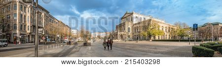 HANNOVER GERMANY - NOVEMBER 23 2017: Unidentified pedestrants cross the ganrd place in front of the opera house.