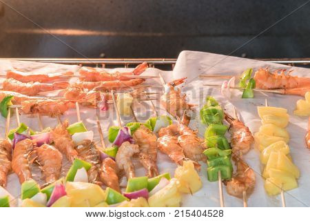 Homemade Skewer With Delicious Grilled Shrimps On Parchment Paper