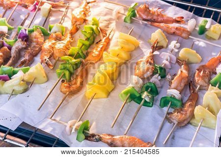 Homemade Skewer With Delicious Grilled Shrimps On Parchment Paper