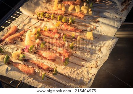 Homemade Skewer With Delicious Grilled Shrimps On Parchment Paper