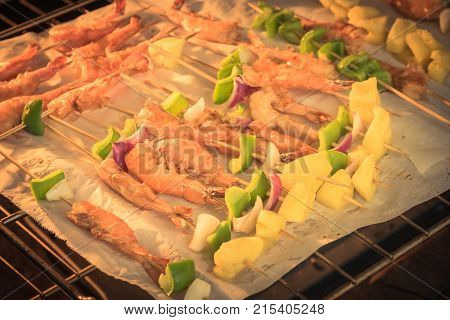 Homemade Skewer With Delicious Grilled Shrimps On Parchment Paper