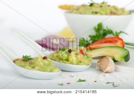Tortilla guacamole dip in white bowl and spoons. Fresh Vegetable dip.