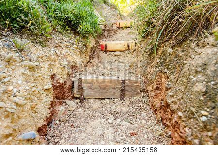 Narrow passage through corridor in rock with carved stairs.
