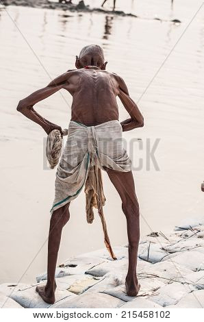 hindu pilgrim washes himself in the holy water of the ganges river in india