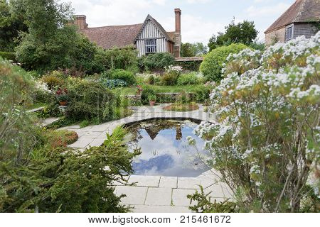 NORTHIAM GREAT BRITAIN - JUN 06 2017: Pond with flowers and plants and buildings in the background. June 06 2017 in Northiam Great Britain