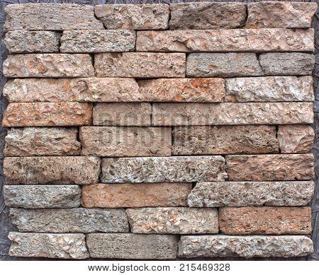 Stone wall texture, travertine tiles facing stone background