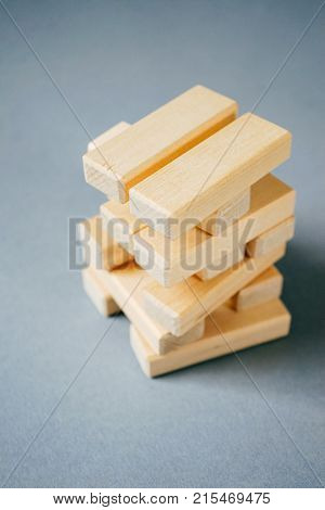 Small construction of small wooden blocks on a white table