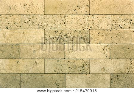Stone wall texture, travertine tiles facing stone background