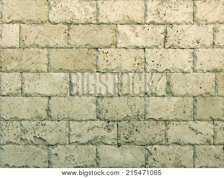 Stone wall texture, travertine tiles facing stone background