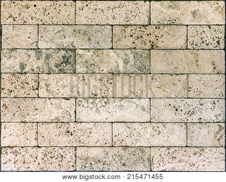 Stone wall texture, travertine tiles facing stone background