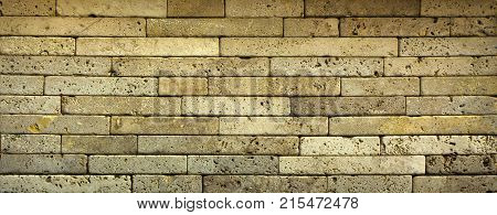 Stone wall texture, travertine tiles facing stone background