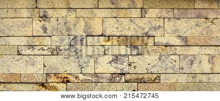 Stone wall texture, travertine tiles facing stone background