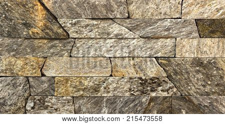 Stone wall texture, travertine tiles facing stone background