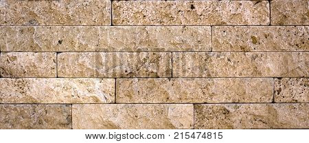 Stone wall texture, travertine tiles facing stone background
