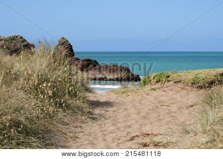 Up and over the sand dune to the sea at Woolleys Bay.