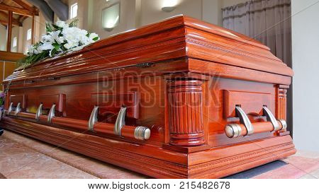 closeup shot of a colorful casket in a hearse or chapel before funeral or burial at cemetery