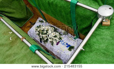 closeup shot of a colorful casket in a hearse or chapel before funeral or burial at cemetery