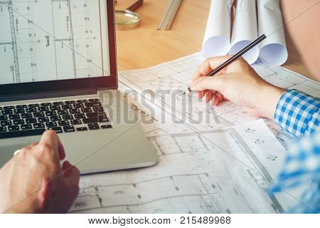 Architect Or Engineer Working In Office On Blueprint. Architects Workplace