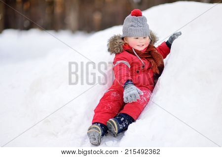 Little Boy In Red Winter Clothes Having Fun With Fresh Snow