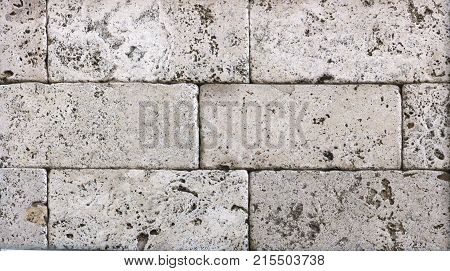 Facing tile from travertine with a smooth surface texture