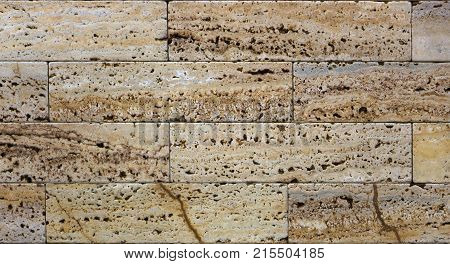 Facing tile from travertine with a smooth surface texture