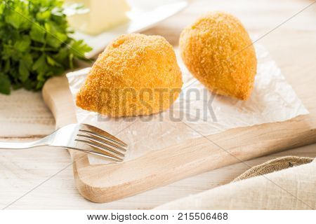 Chicken Kiev cutlets with parsley leaves and butter.