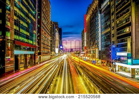 Twilight in the city with movement car light and clear light box on the building., Taipei Main Station, Taiwan.