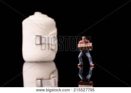 Bandage used for injuries during work leisure time or in housework isolated on glossy black background