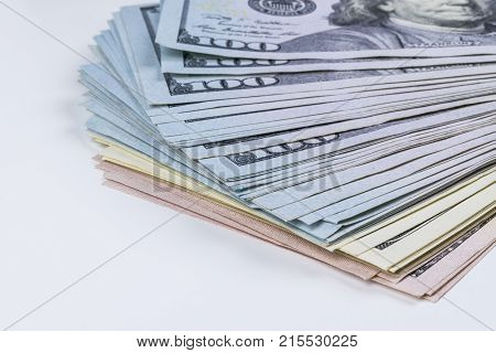 Stack of one hundred dollar bills. Stack of cash money in hundred dollar banknotes. Heap of hundred dollar bills on white background