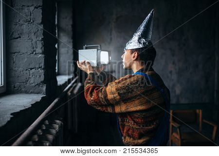 Paranoid man in tinfoil cap, mind protection, UFO