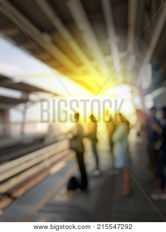 Abstract Blurred Image Of People Waiting For Train Coming And Using Mobile Phone In Electric Sky Tra